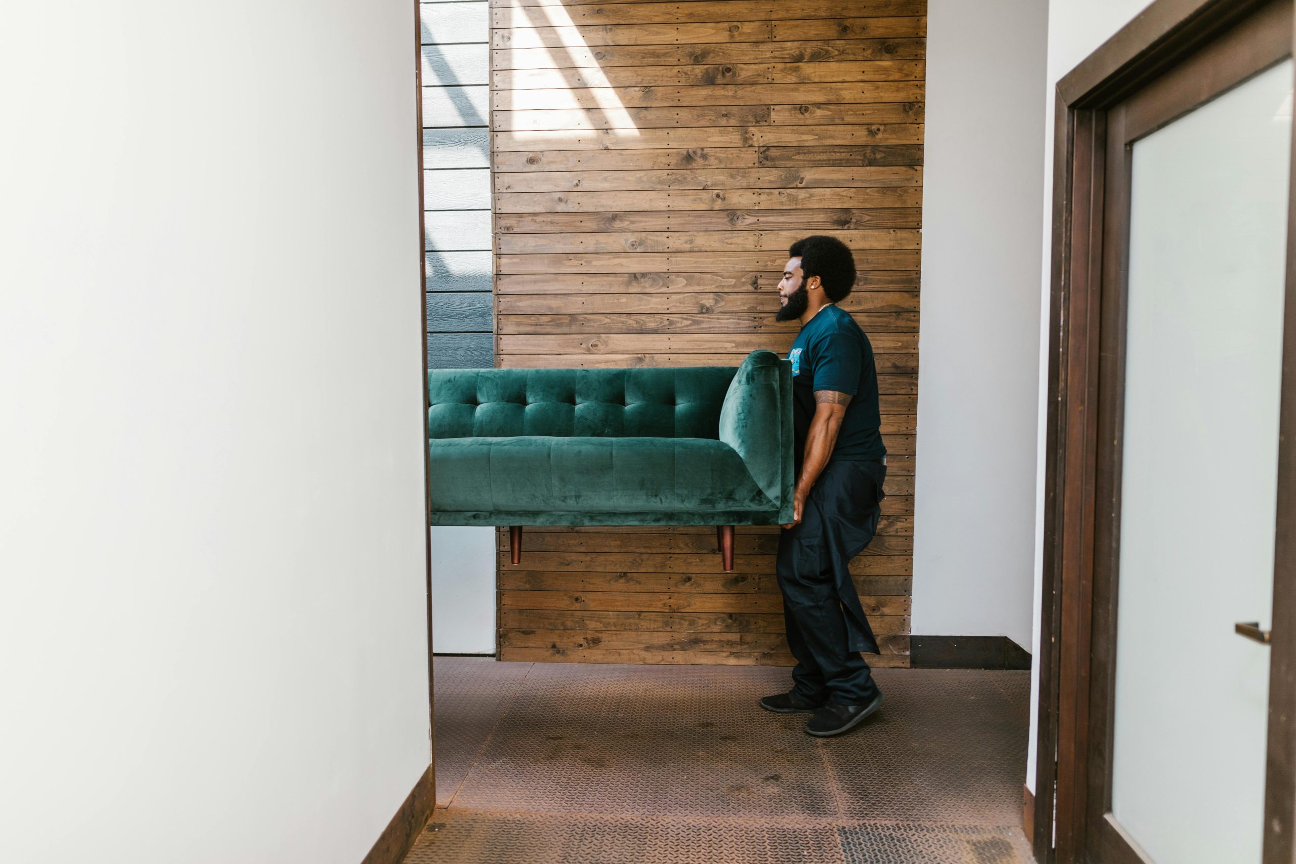 man carrying couch and hoping it will fit in his van size